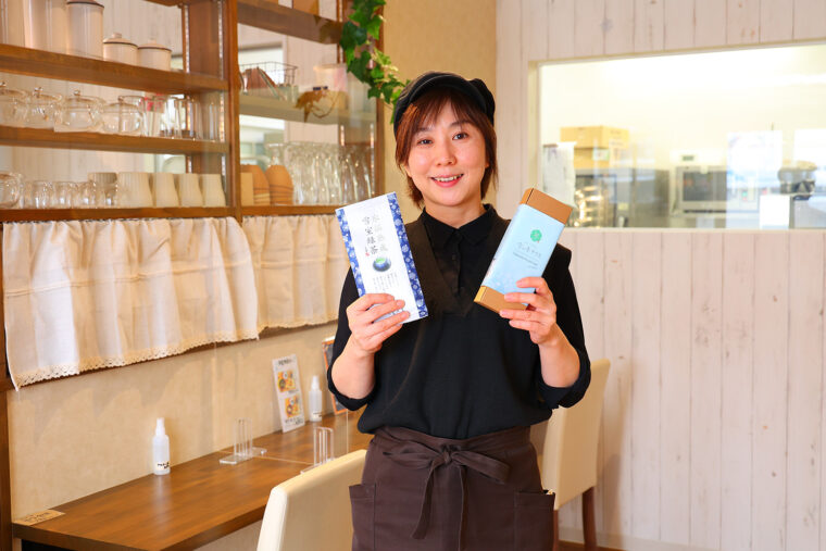 スタッフの松木さんが持っているのは、オリジナル商品の『雪の香パウンドケーキ（プレーン）』（右972円）『氷温熟成 雪室緑茶』（左80g 1,080円）
