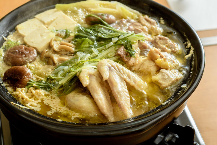 ぐつぐつをした鍋の蓋を開ければ鶏のうまみたっぷりの黄金色のスープが姿を現す