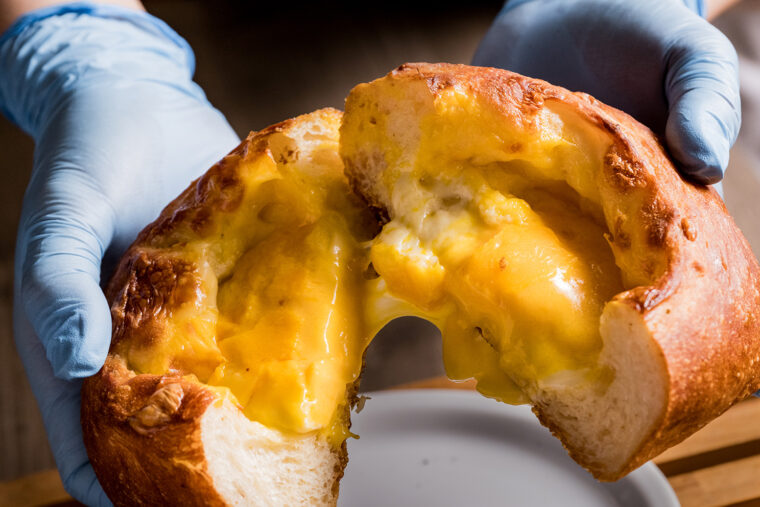 『とろーりチーズぱん』（1個700円、1/2カット350円）。温めてからカットすると4種類のチーズが滝のように流れ出てく